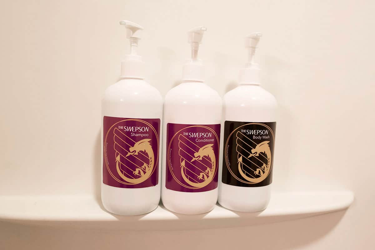 wyvern logo toiletries with purple label for shampoo conditioner bottle