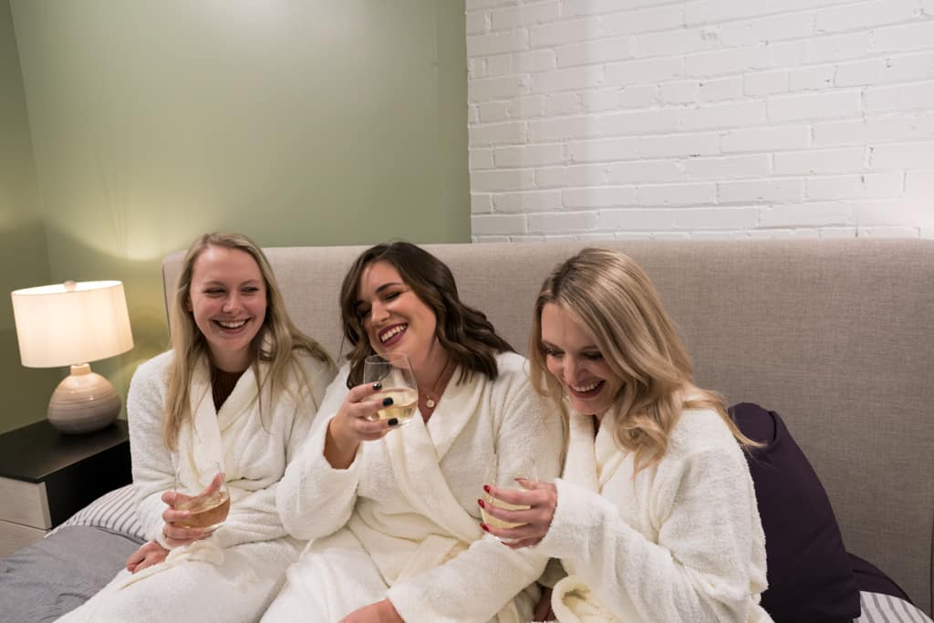 Bride with bridemaids sharing champagne at the bachelorette party
